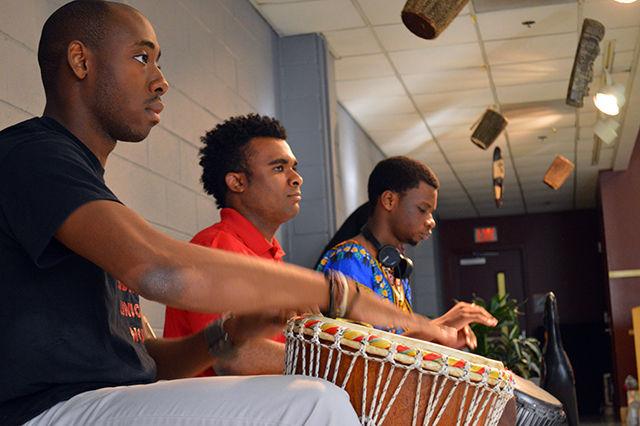 Drummers Kevin Ohuoba, a sophomore studying accounting,Carlos McClaney, a senior studying technology design and engineering education, and Ade Adesina, a sophomore in Exploratory Studies, perform the ceremonial welcome, Call of the Drums, during the annual Harambee celebration held in Witherspoon's Sancofa Room on Tuesday, September 1st. "The drums, or djembes, derive from the Gambia says McClaney. "They are used to pass down tradition and oral history." The rhythm performed, fanga, is a combination of the Gambian and Nigerian culture and is a tool utilized to welcome new brothers and sisters into a united community.