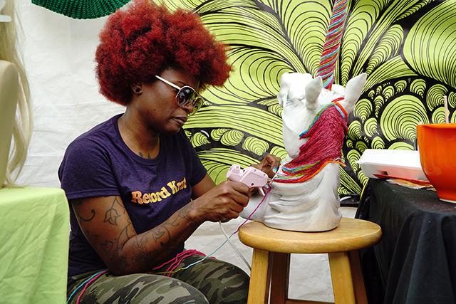 Lakeesha Fradella, the owner of Martian Creations, carefully glues yarn onto a unicorn bust on 9/19. Fradella started Martian Creations to combine her love for crocheting and her eccentric artistic style. This was her 3rd year coming to SPARKcon. The bazzarSPARK section of SPARKcon was reserved for local artisans and vendors.