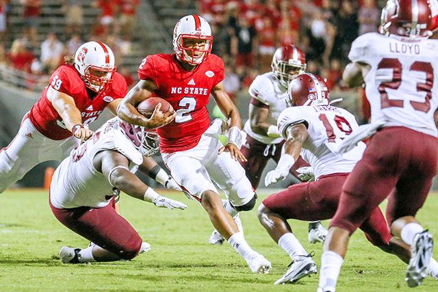 Redshirt Freshman Jalan McClendon scrambles for five yards against the Troy Trojans Sept. 5. McClendon was able to fill in for Brissett after the Wolfpack gained a significant lead in the fourth quarter of the game. The Wolfpack defeated the Trojans 49-21 in their first game of the season.&#160;