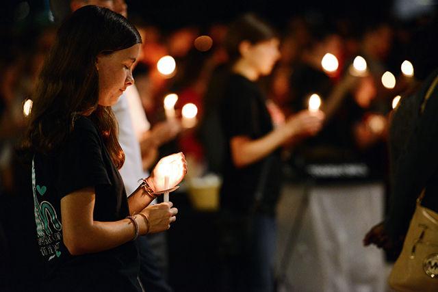 Ashlee Hilburn, a junior studying communication, keeps her candle lit during the Candlelit Vigil held in memory of Joseph Banks on Stafford Commons Tuesday, Sept. 15. About 1,300 people came out to honor Banks.