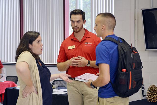 Tiffany McLean, director of enrollment management for the College of Natural Resources, and Cody Brooks, a senior studying Forest Management, gives a student more information about Forest Management. On Sept. 28th, the College of Natural Resources hosted a Major Exploration Series Open House. The event gave students, exploring or undecided, the opportunity to explore the different majors within the college. Several student ambassadors, like Brooks, were scattered around the room to tell about their own experience in the College of Natural Resources.