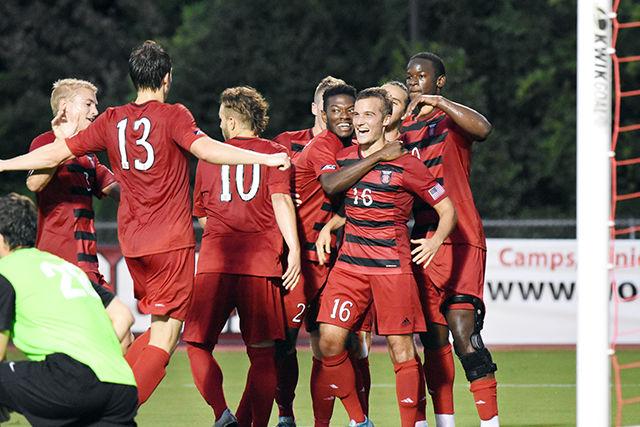 Freshmen midfielder Julius Duchscherer celebrates with his teammates after scoring Wolfpack's first goal in the 41st minute. Duchscherer's goal, assisted by Simon Blotko, was his only score on six shots during the game against College of Charleston. The Wolfpack won the game 2-0 on Aug. 31 at Dail Soccer Stadium.