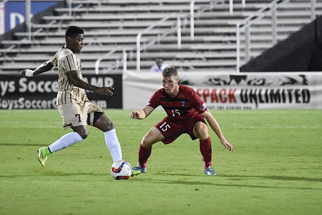 Sophomore midfielder Cameron Steele defends his position against College of Charleston player, Adan Noel. Steele had two shots during the game. The Wolfpack won their regular season home opener, 2-0 on Aug. 31 at Dail Soccer Stadium.