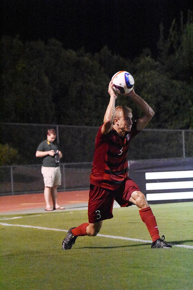 Sophomore defender Caleb Duvernay throws in the ball to his teammates. Duverney had a shot during the game. The Wolfpack won their regular season home opener against College of Charleston, 2-0 on Aug. 31 at Dail Soccer Stadium.