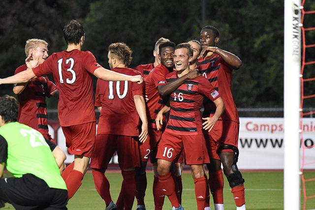 Freshmen midfielder Julius Duchscherer celebrates with his teammates after scoring Wolfpack's first goal in the 41st minute. Duchscherer's goal, assisted by Simon Blotko, was his only score on six shots during the game against College of Charleston. The Wolfpack won the game 2-0 on Aug. 31 at Dail Soccer Stadium.
