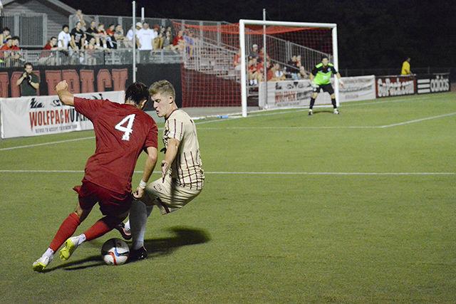 Junior midfielder Yanni Hachem battles a Charleston defender for a shot on goal in Dail Soccer Stadium. Hachem had one goal off an exciting penalty kick that led the NC State Men's Soccer Team to a 2-0 win in the Aug. 31 game.