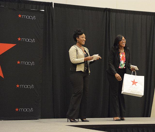 April Clark and Saisha Delevoe, representatives from Macy's, present prizes at the end of the Career Development Center fashion show on Monday. During the show Clark and Delevoe gave tips on appropriate clothing to wear to the office, job interviews, and other work-related events. Clark is also the author of the fashion and lifestyle blog, "What Would April Wear?"