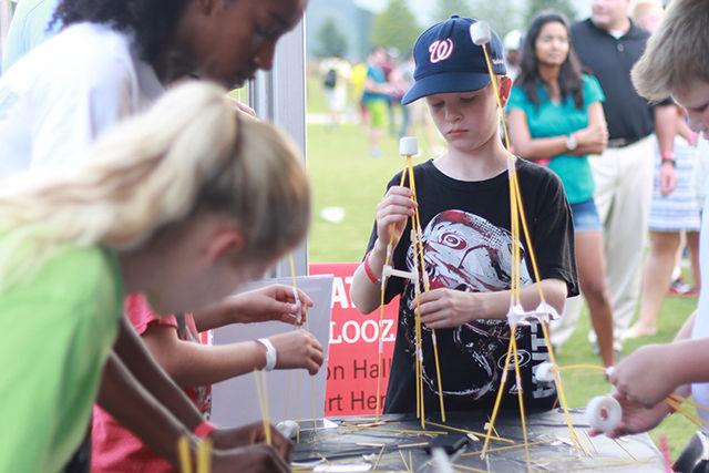 Donovan Riley, a fifth grade student studying at Washington Elementary School, Raleigh tries his hands on Marshmellow challenge during Entrepalooza, on the Oval on Thursday, Sept 3, 2015.