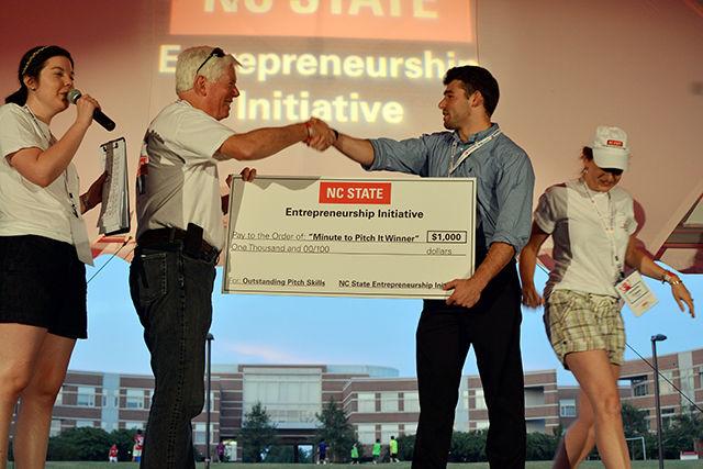 Oliver Walsh, a Junior studying Electrical Engineering accepts the cheque for winning Minute to Win It Pitch Competition at Entrepalooza. Entrepalooza is an annual enrepreneurship and innovation festival hosted by the NC State Entrepreneurship Initiative. The event took place at The Oval Thursday on September 3, 2015.