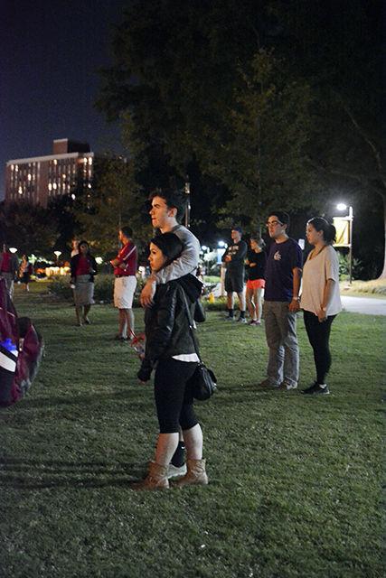 Melora Trowell, a junior studying chemical engineering, and Rob Williford, senior studying computer science, gather on Stafford Commons Tuesday night for the candlelit vigil in honor of freshman Joseph Banks. This was the second candlelit vigil held for Banks.