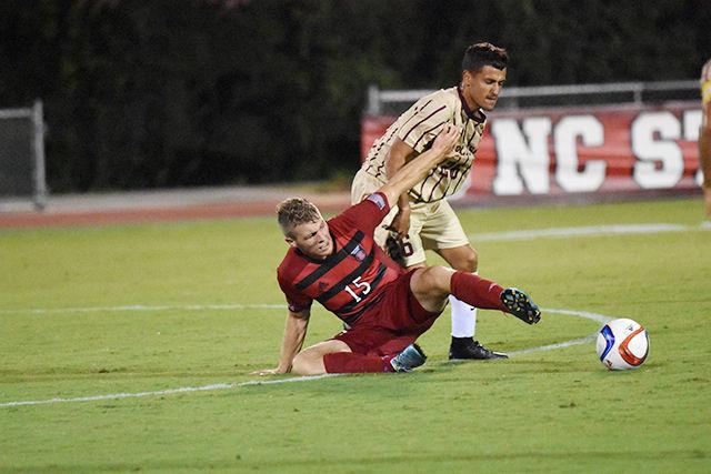 Sophomore midfielder Cameron Steele fights for possession against College of Charleston defender Nicholas Jeausseran. Steele had two shots during the game. The Wolfpack won their regular season home opener, 2-0 on Aug. 31 at Dail Soccer Stadium.