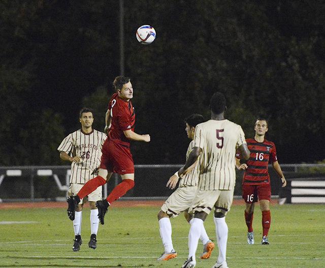 Sophomore forward Ryan Peterson heads the ball away from a group of defenders from the College of Charleston. The Wolfpack won the game 2-0 at Dail Soccer Stadium Aug. 31.