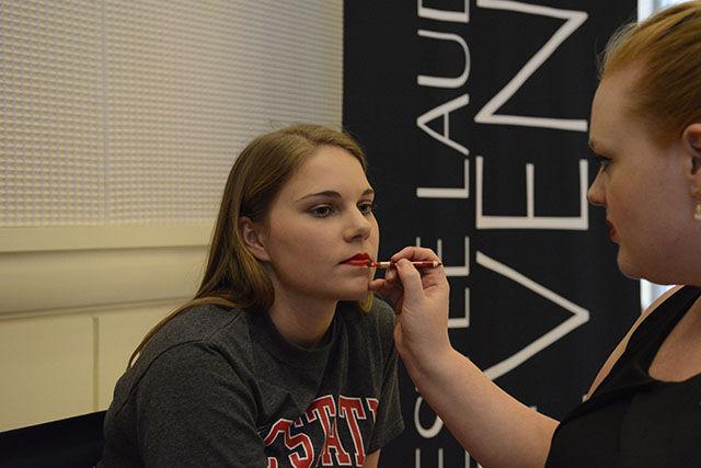 Kelly Doss, a senior studying mathematics, gets her makeup done by a representative at Est&#233;e Lauder before the Career Development Center fashion show on Monday. Doss is an ambassador for the CDC and this was her first time walking in the fashion show. "I'm very excited!" she said.