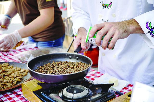 The Bug Chef, Zack Lemann, adds seasoning to crickets at Bugfest on 9/19. This dish features house crickets, which are one of the most common types of crickets in NC.