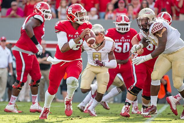 Redshirt Junior Quarterback Jacoby Brissett throws an 8 yard touchdown pass to Johnathan Alston during the game against No. 1 Florida State in Carter-Finley Stadium Saturday, Sept. 27, 2014. Despite a strong start, the Wolfpack fell to the Seminoles, 56-41. Photo by Ben Salama.
