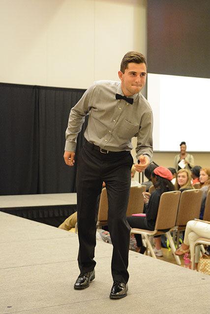 Holton Ramoin, an ambassador for the Career Development Center and senior in marketing, strikes a pose at the CDC Fashion Show on Monday. "My favorite part of the show was having the opportunity to try on all the nice clothes," he said. "They were way nicer than anything I have in my closet!"