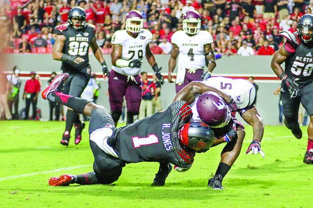 Graduate safety Hakim Jones drags down the Colonels' running back. Hakim Jones finished the game with 5 solo tackles and 1 tackle for a loss. NC State shutout the Eastern Kentucky Colonels 35-0 in Carter-Finley Stadium on Sept. 12.&#160;