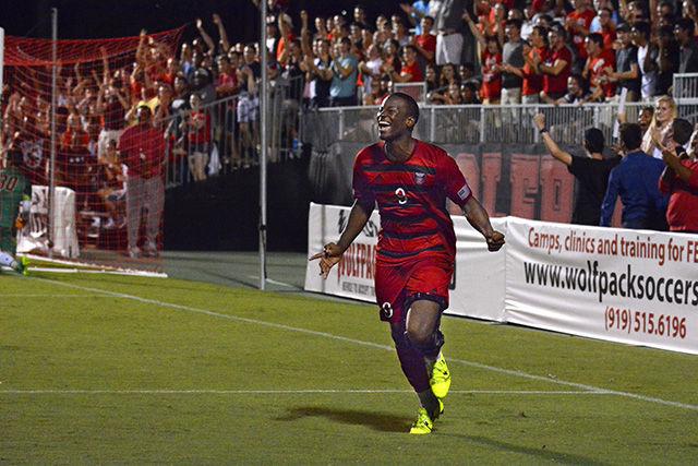 Ade Taiwo celebrates his goal against Boston College, the first goal made by NC State. Taiwo took two shots on goal Friday night and made one. NC State won in the final minutes of the second overtime half with a final score of 2-1. The game took place September 11th at Dail Soccer Stadium.
