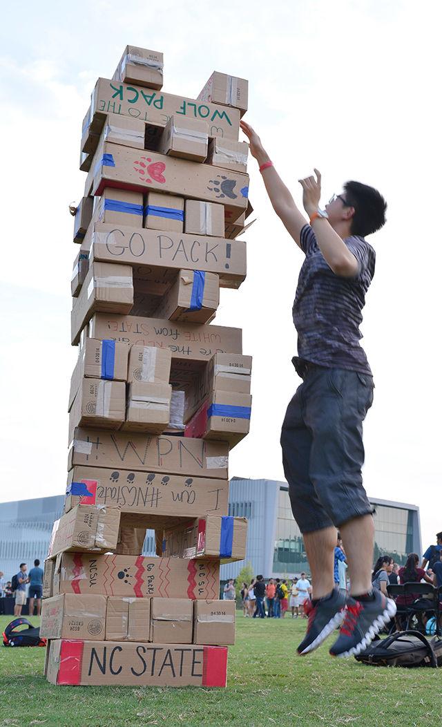 Qiaoyi Liu studying Computer Engineering attempts to stack 16th level while playing Jenga at Entrepalooza. Entrepalooza is an annual enrepreneurship and innovation festival hosted by the NC State Entrepreneurship Initiative. The event took place at The Oval Thursday on September 3, 2015.