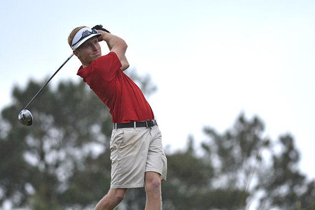 Junior David Cooke drives the on the 18th hole at the Wolfpack Spring Open on Sunday afternoon. Cooke was the overall champion of the tournament with a score of -10 and the Wolfpack finished first with -17 at Lonnie Poole Golf Course April 19, 2015.