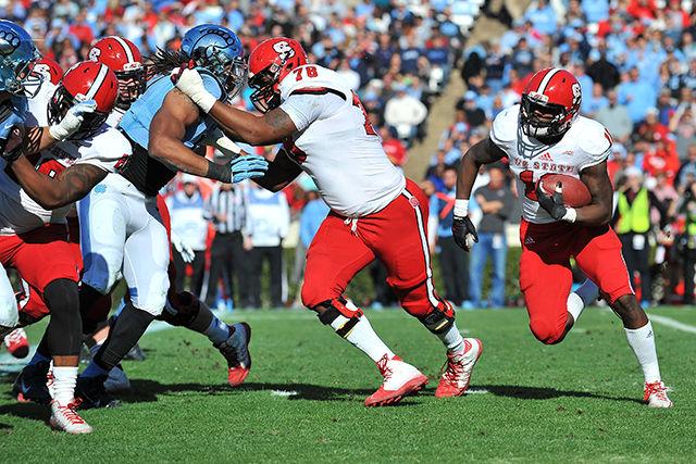 Junior runningback Shadrach Thornton runs the ball during the game against North Carolina Saturday, Nov. 29, 2014. Thornton had 161 rushing-yards in the Wolfpack's 35-7 win over the Tar Heels at Kenan Stadium in Chapel Hill, NC.