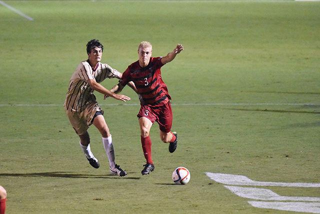 Sophomore defender Caleb Duvernay dribbling away from College of Charleston defender. Duverney had a shot during the game. The Wolfpack won their regular season home opener, 2-0 on Aug. 31 at Dail Soccer Stadium.