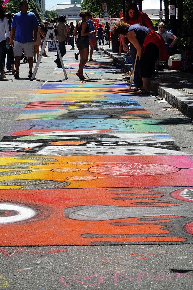 A series of street paintings on Fayetteville Street on 9/19. Street painting is a major part of SPARKcon's art section, where schools, organizations, and families can buy squares on the street to paint on.