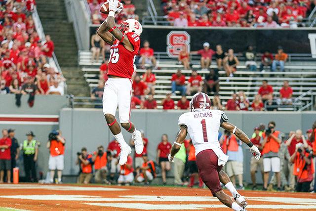 Junior wide receiver Jumichael Ramos leaps high in the air for a 14-yard touchdown catch against the Troy Trojans on Sept. 5. Ramos had three receptions for 45 yards and a touchdown. The Wolfpack defeated the Trojans 49-21 in its first game of the season.