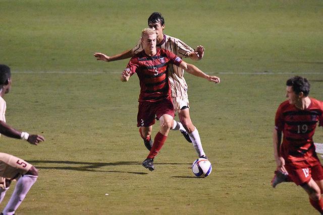 Sophomore defender Caleb Duvernay dribbling away from College of Charleston defender. Duverney had a shot during the game. The Wolfpack won their regular season home opener, 2-0 on Aug. 31 at Dail Soccer Stadium.