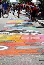 A series of street paintings on Fayetteville Street on 9/19. Street painting is a major part of SPARKcon's art section, where schools, organizations, and families can buy squares on the street to paint on.