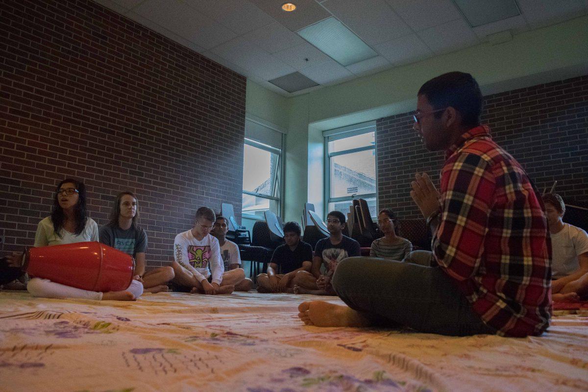 Members of the SEVA Bhakti Yoga Club chant a matra during their weekly meeting on Thursday Sept. 10. Through musical mantra meditation, Bhakti philosophical teachings and homemade vegetarian dinner, the club seeks to help members lead a balanced life.