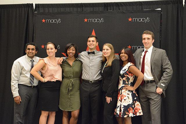 The student ambassador models for the Career Development Center fashion show pose after walking the runway on Monday. The CDC has put on the fashion show every year to help students decide what to wear on the job, to interviews and office parties, and other job related events. "My favorite part of the whole thing was bonding with my fellow ambassadors," said Sarah Bowman, senior in public relations.