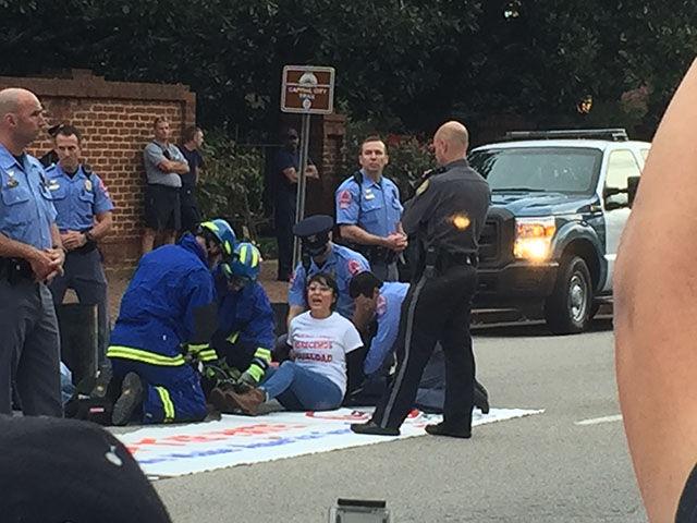 Nayely Perez is arrested after being separate from her companions in the street in front of the Governor's Mansion on Thursday.&#160;