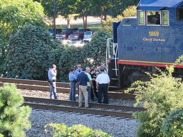 Law enforcement and Amtrack officials consort in front of Piedmont Train 74, a passenger train coming into Raleigh from Charlotte, which struck a pedestrian who was trespassing on the track near Sullivan Hall. The pedestrian has been identified as Maurice Sutton, 51.