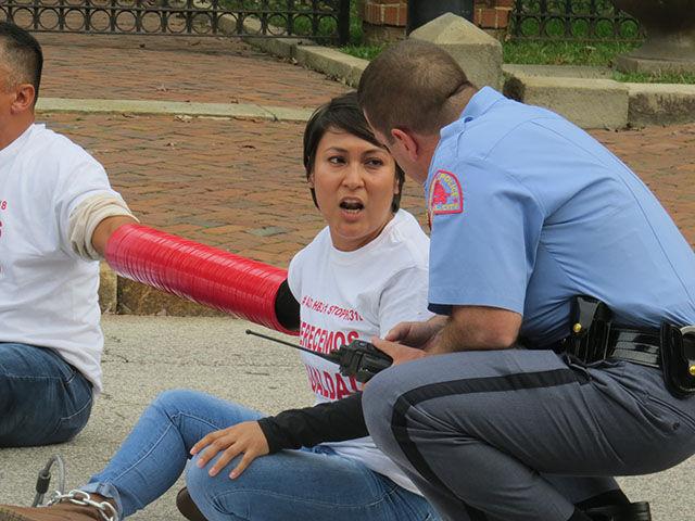 Nayely Perez speaks with a police officer in front of the Governor&#8217;s Mansion on Thursday.