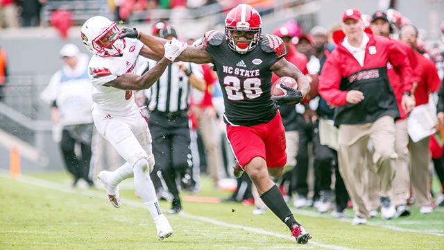 Tight end fullback Jaylen Samuels stiff arms a Louisville defender. Samuels had five receptions for 75 yards in the 13-20 loss to Louisville in Carter-Finley Stadium on Oct. 3.