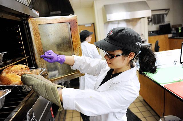 Echo Li, who graduated with a doctorate in food science, prepares a turkey for a group study. According to Kara McCarthy, a research assistant in the food science department, when the surveys require a cooked meal, they have to coordinate the cooking&#160; and subjects to give the whole testing group the meal hot.&#160;