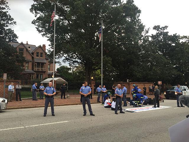Police stand guard in between the protesters in front of the Governor's Mansion in Downtown Raleigh on Thursday.