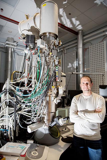 Jacob Jones, a professor in the Department of Materials Science and Engineering, stands next to the FEI Titan Electron microscope (STEM). The FEI Titan STEM microscope is the most advanced aberration-corrected scanning transmission electron microscope in a research park in North America. Jones is the director of the Analytical Instrumentation Facility (AIF) at NC State, a university and regional resource for materials characterization. Jones has published more than 100 papers and delivered more than 60 invited lectures on these topics since 2004. He has also received numerous awards on his research and educational activities.