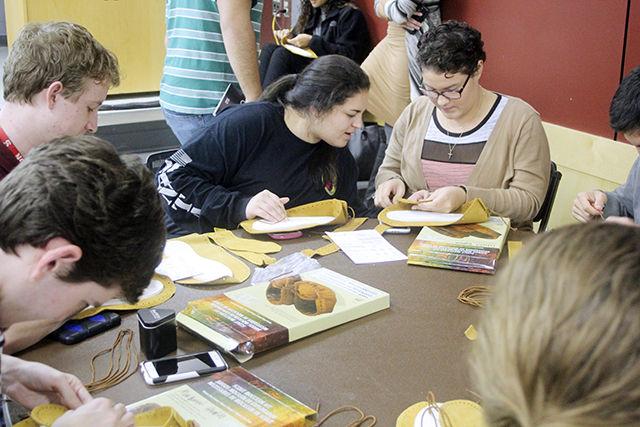 Alexis Springs, a freshman studying exploratory studies and Olivia Bullard a graduate student studying physiology, make moccasins at the Rock Your Mocs event Nov. 9. This event was one of many Native American Heritage Month activities on campus. After building the moccasins, students are encouraged to wear them all week. The event was co-sponsored by Cisco.