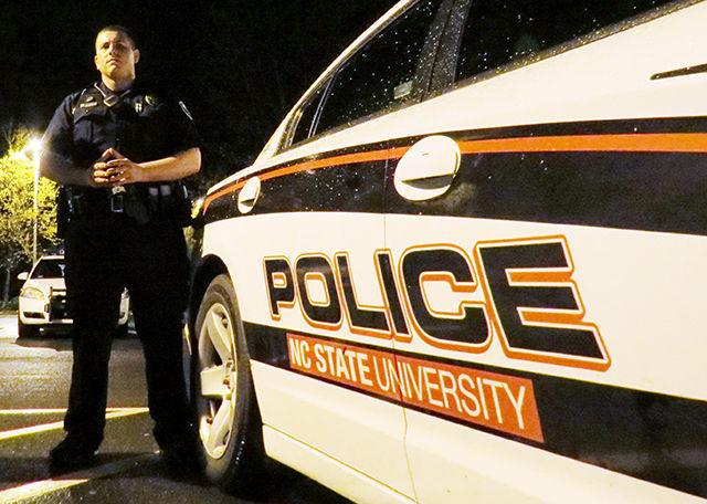 Officer David Green with Technician staff writer Russell Ash after their ride-along on Thursday night. The Campus Police Department offers the Ride Along program as a way to &#8220;increase understanding between Officers in the Campus Police Department and the University community&#8221; and to serve as means to educate the community, according to the department&#8217;s webpage. photo by Gavin Stone