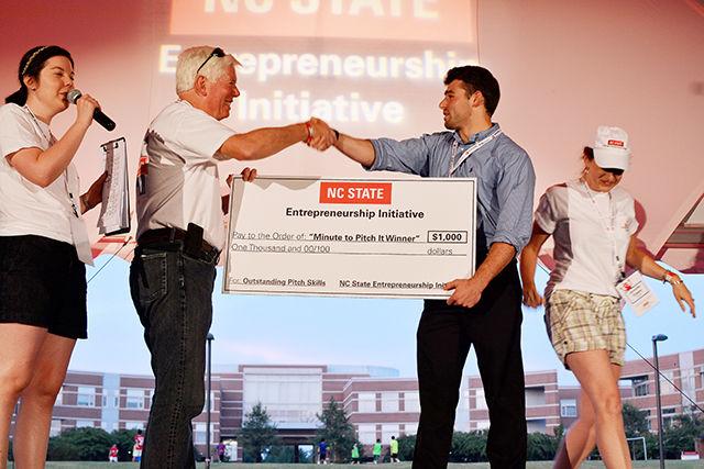 Oliver Walsh, a junior studying electrical engineering accepts the check for winning Minute to Win It Pitch Competition at Entrepalooza. Entrepalooza is an annual entrepreneurship and innovation festival hosted by the NC State Entrepreneurship Initiative. The event took place at the Oval Sept.3.