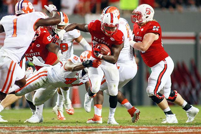 Redshirt sophomore runningback Dakwa Nichols strips the No. 3 Clemson defense. Nichols had two rushes for seven yards towards the end of the game. The Wolfpack lost the homecoming game 56-41 in Carter-Finley stadium on October 31st.
