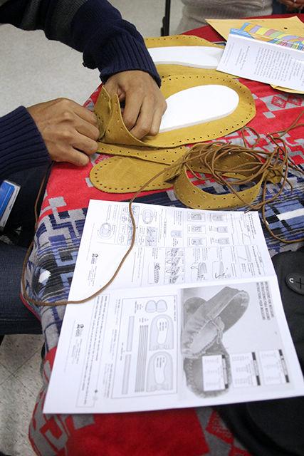 Glendale Basnight, a Cisco employee, builds moccasins at the Rock Your Mocs event Nov. 9. This event was one of many Native American Heritage Month activities on campus. After building the moccasins, students are encouraged to wear them all week. The event was co-sponsored by Cisco.