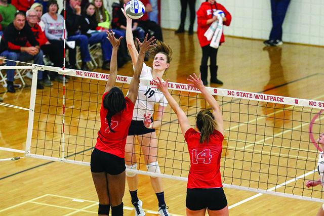 Sophomore Outside Hitter Perry Ramsey and Freshman Middle Blocker Blayke Hranicka attempt to block a spike by Pitt Outside Hitter Kadi Kullerkann. Although they won the opening set 30-28, NC State Woman's Volleyball fell to the Pitt Panthers in a five set thriller, 3-2, on November 14, 2015 at Carmichael gymnasium.