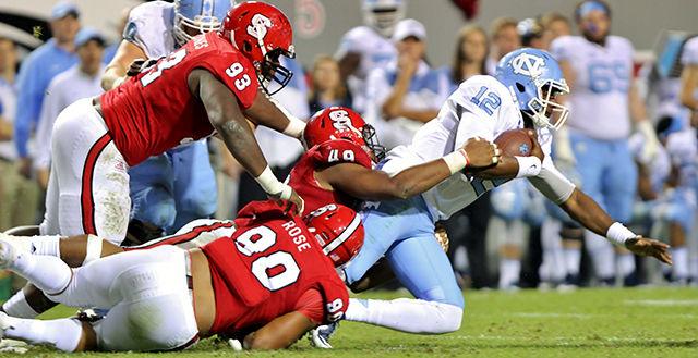 Sophomore defensive end Bradley Chubb, graduate defensive end Mike Rose and sophomore defensive tackle Justin Jones tackle UNC quarterback Marquise Williams at Carter Finley Stadium on November 28. The wolfpack defense held Williams to 53 yards rushing on 10 attempts. Despite outscoring the tarheels by 10 points in the second half, the wolfpack lost the game 45-34.