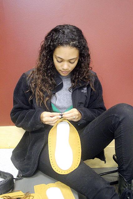 Maxine Boone, a senior studying science, technology and society, crafts moccasins at the Rock Your Mocs event Nov. 9. This event was one of many Native American Heritage Month activities on campus. After building the moccasins, students are encouraged to wear them all week. The event was co-sponsored by Cisco.