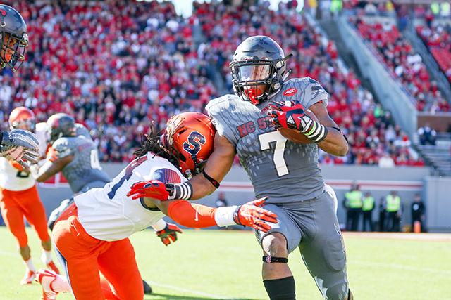 Freshman wide receiver Nyheim Hines sprints to the sideline on a kick return, stiff-arming a Syracuse defender in the process. Hines finished with six rushes for 70 yards and a touchdown, along with five receptions for 69 yards. Hines also had three kickoff returns for 69 yards. The NC State Wolfpack beat the Syracuse Orange 42-29 at Carter-Finley Stadium on Saturday to go to a record of 7-4 with a conference record of 3-4.