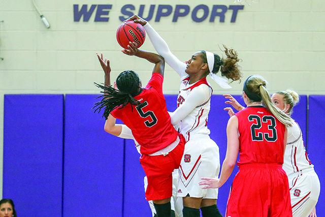 Junior guard Miah Spencer goes up for the block against a Wildcat player in the first half of the basketball game. Spencer finished with game with 2 points on 1 for 2 shooting in 9 minutes before leaving the game with a thumb injury. The woman&#8217;s basketball team won convincingly against the Davidson Wildcats 58-42 on November 22nd, 2015 at Broughton High School.