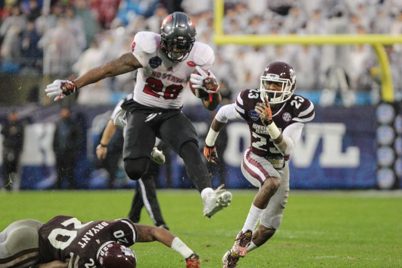 Sophomore TE/FB Jalen Samuels hurdles a defender on the way to a 48 yard touchdown on December 30 at Bank of America Stadium. Samuels had 53 yards rushing in the game. The Wolfpack lost to Mississippi State 28-51.